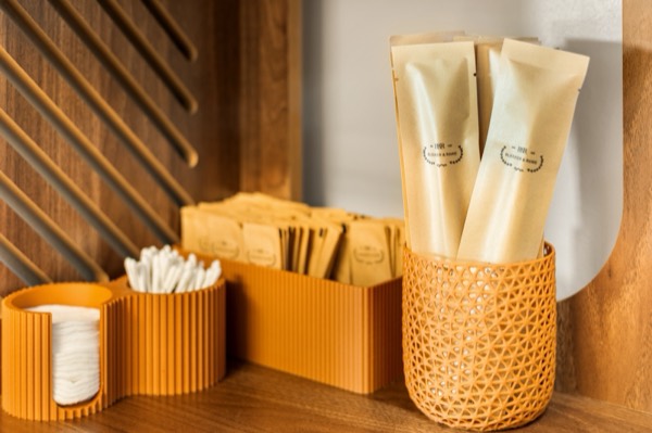 Cotton pads, swabs and wrapped toiletries in woven and terracotta holders